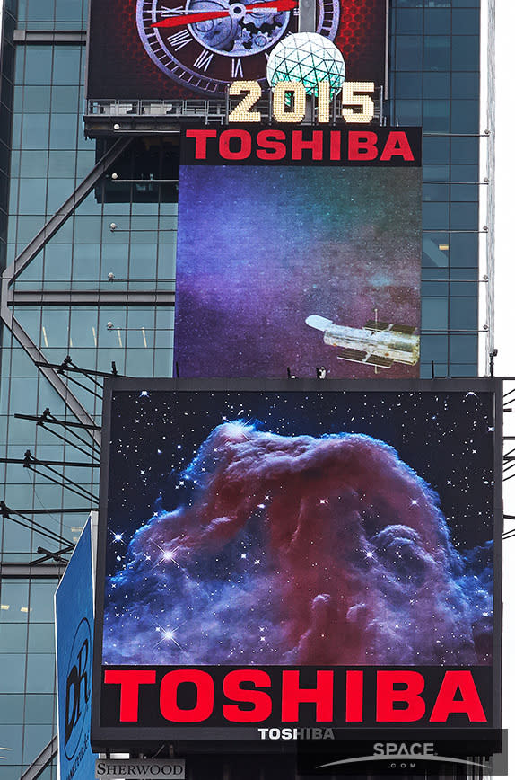 An image of the horse head nebula, taken by the Hubble Space Telescope appears on the lower of two screens in Times Square shoing Hubble-related images through April 26. On the top screen, a shot featuring the telescope.