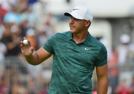 Aug 12, 2018; Saint Louis, MO, USA; Brooks Koepka celebrates after putting on the 18th green during the final round of the PGA Championship golf tournament at Bellerive Country Club. Jeff Curry-USA TODAY Sports