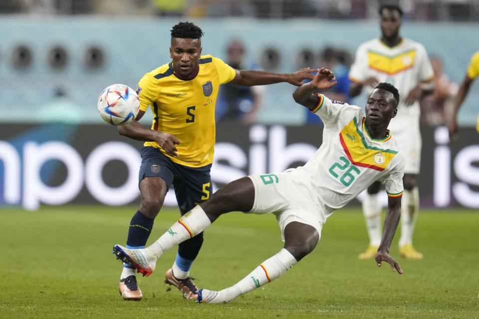 Senegal's Pape Gueye and Ecuador's José Cifuentes fight for the ball during the World Cup group A soccer match.