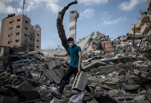 A Palestinian man inspects the damage of a six-storey building destroyed by an early-morning Israeli airstrike in Gaza City Tuesday.