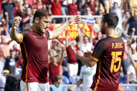 AS Roma's captain Francesco Totti (L) celebrates with Miralem Pjanic after scoring against Sassuolo during their Serie A soccer match at Olympic stadium in Rome September 20, 2015. REUTERS/Giampiero Sposito