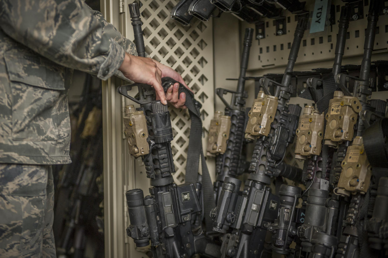 In this April 2, 2015, photo made available by the U.S. Air Force, a senior airman from the 49th Security Forces Squadron in charge of the armory,  returns an M4 carbine to a rack at Holloman Air Force Base, N.M. The Pentagon used to share annual updates about missing weapons with Congress, but that requirement ended and, with it, public accountability has slipped. The Army and Air Force couldn’t readily tell AP how many weapons they were missing from 2010 through 2019. (Airman 1st Class Aaron Montoya/U.S. Air Force via AP)