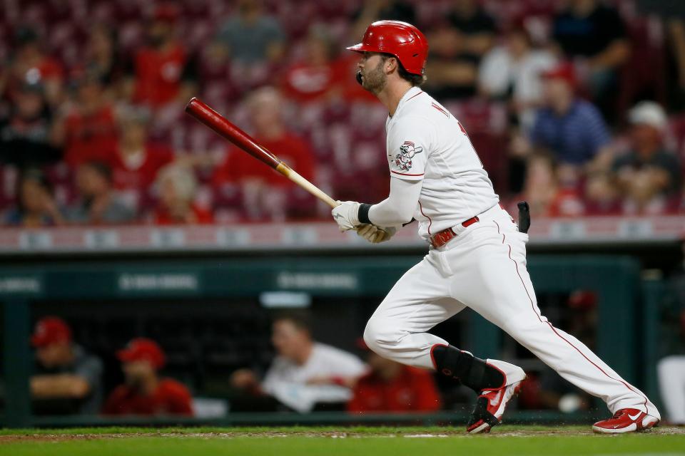 Cincinnati Reds right fielder Tyler Naquin (12) scores two runs on an RBI double with the bases loaded in the eighth inning of the MLB National League game between the Cincinnati Reds and the Milwaukee Brewers at Great American Ball Park in downtown Cincinnati on Tuesday, May 10, 2022. The Brewers came back for a 5-4 win. 