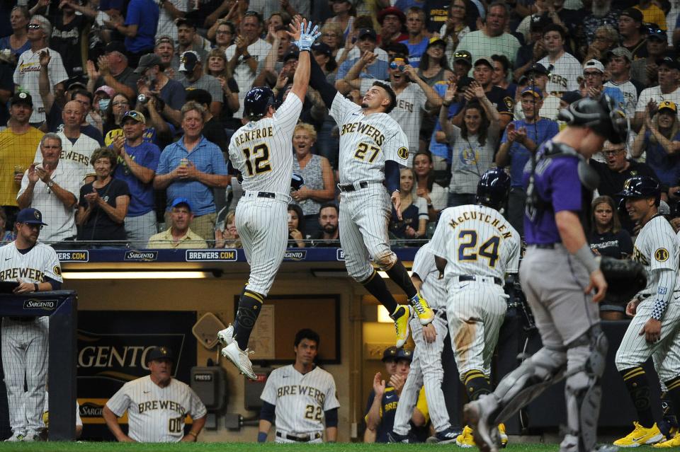 Brewers rightfielder Hunter Renfroe gets a leaping high-five from Willy Adames after he belted a three-run home run against the Rockies during the fourth inning Saturday night.