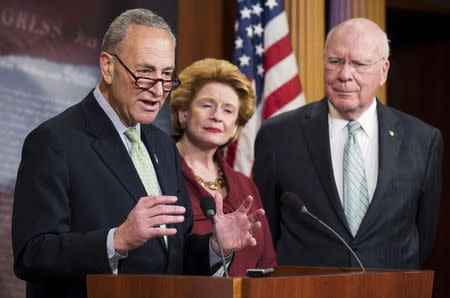 U.S. Senator Charles Schumer (D-NY) (L) speaks as Debbie Stabenow (D-MI) (C) and Patrick Leahy (D-VT) (R) look on, after the cloture vote on the nomination of Loretta Lynch to be Attorney General, on Capitol Hill in Washington April 23, 2015. REUTERS/Joshua Roberts