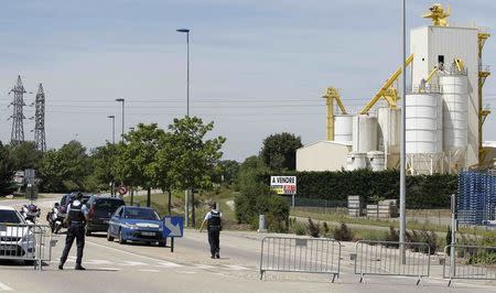 French Gendarmes block the access road to the industrial area of Saint-Quentin-Fallavier, outside Lyon, France, June 26, 2015. REUTERS/Emmanuel Foudrot