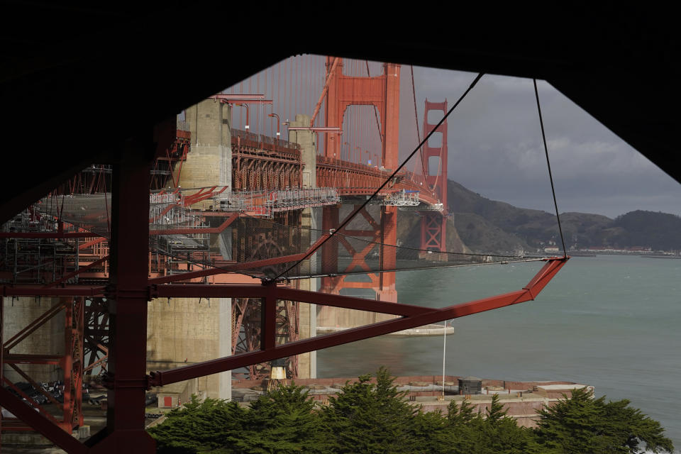 A suicide deterrent net is seen under construction on the Golden Gate Bridge in San Francisco, Wednesday, Dec. 6, 2023. The barrier at the bridge is near completion more than a decade after officials approved it. (AP Photo/Eric Risberg)