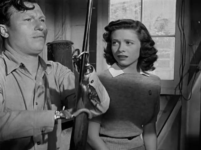 Harold Russell tries to put something away with hooks for hands as a girl looks on sadly
