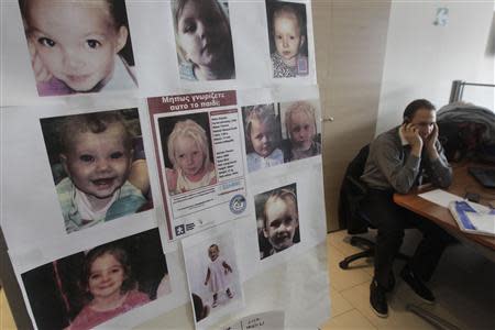 Photographs of young missing girls, including the poster of the girl found living with a Roma couple in central Greece, are seen in the offices of the "Smile of the Child" charity which is taking care of a child found living with a Roma couple in central Greece, as police search for her biological parents, in an Athens suburb October 21, 2013. REUTERS/John Kolesidis