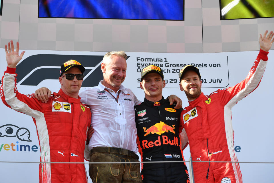 Glasses on, smile off: Second-placed Kimi Raikkonen is by far the glummest person on the Austria podium, with good reason