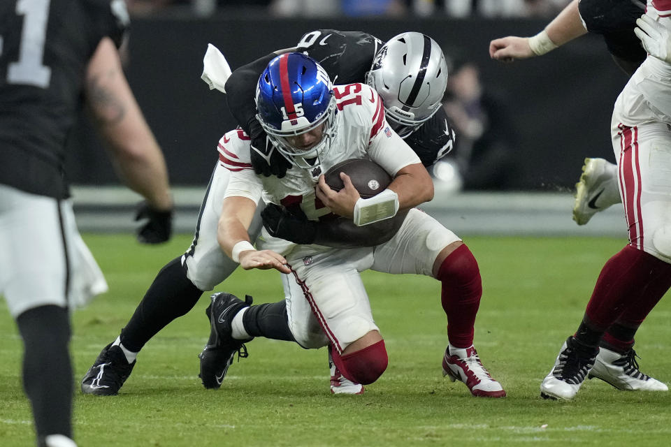 Las Vegas Raiders defensive tackle Bilal Nichols sacks New York Giants quarterback Tommy DeVito (15) during the second half of an NFL football game, Sunday, Nov. 5, 2023, in Las Vegas. (AP Photo/John Locher)