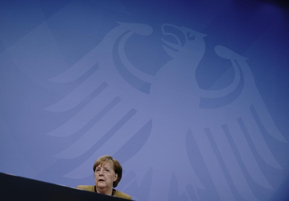 Germany's Chancellor Angela Merkel takes part in a press conference following the consultations between the federal and state governments on further COVID measures, in Berlin, Tuesday, Jan. 5, 2021. (Michael Kappeler/pool photo via AP)