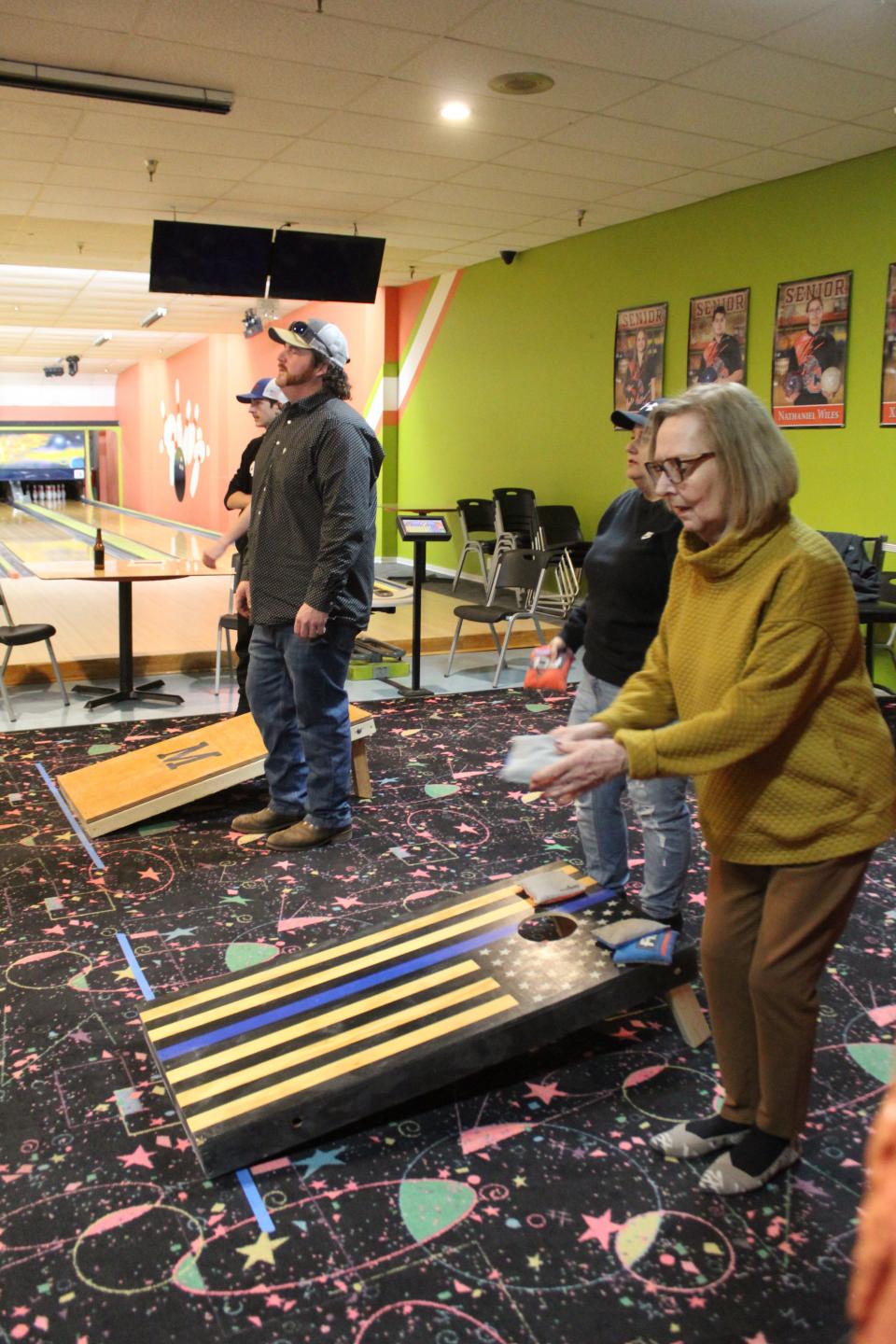 Cornhole players from all over the state, as well as several local players, including Mary Hebert, participated in the fundraiser tournament on Sunday.