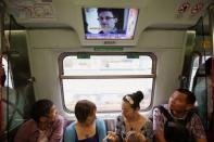 Passengers watch a television screen broadcasting news about Edward Snowden on a train in Hong Kong, June 14, 2013. The former U.S. spy contractor Edward Snowden created an international furore when he revealed U.S. surveillance secrets to the media. Snowden was in Hong Kong when the first stories about the leaks were published. As Washington sought his extradition, Hong Kong allowed Snowden to leave in June for Moscow where he was given asylum. Supporters see him as a whistle-blower who boldly exposed government excess, but others consider him a traitor. REUTERS/Bobby Yip/File photo