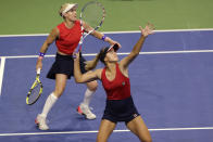 United States' Sofia Kenin prepares to hit an overhead as she and Bethanie Mattek-Sands play Latvia's Jelena Ostapenko and Anastasija Sevastova during the doubles match in Fed Cup tennis qualifying tie Saturday, Feb. 8, 2020, in Everett, Wash. (AP Photo/Elaine Thompson)