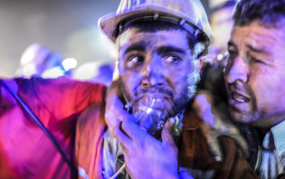 A miner celebrates with his father (R) after an explosion on May 13, 2014 in Manisa. (BULENT KILIC/AFP/Getty Images)