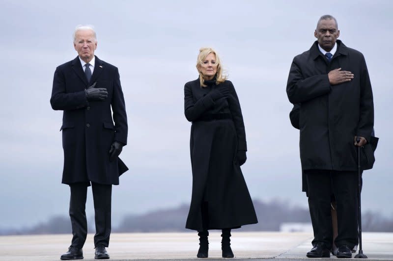 President Joe Biden (L-R), first lady Jill Biden and Secretary of Defense Lloyd Austin stand during a dignified transfer at Dover Air Force Base in Dover, Del., on Friday. Photo by Bonnie Cash/UPI