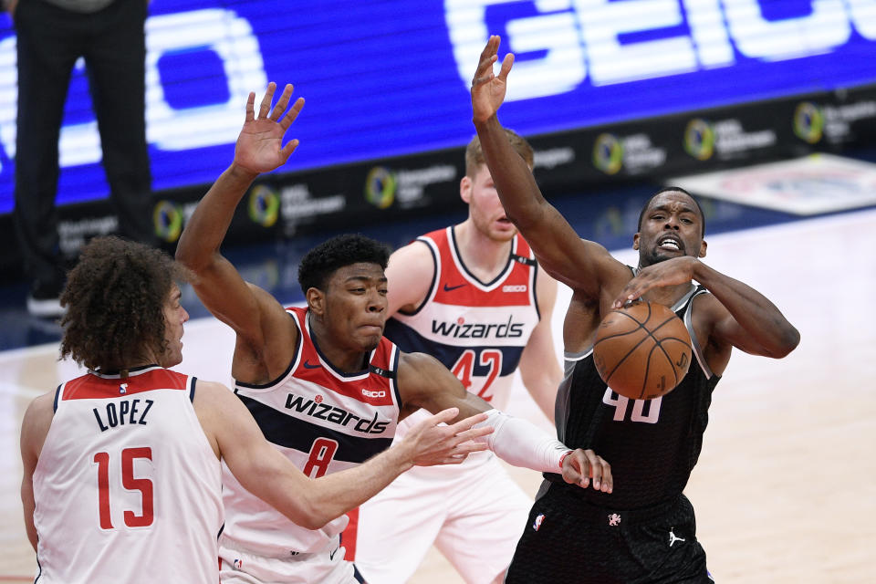 Sacramento Kings forward Harrison Barnes (40) loses the grip on the ball against Washington Wizards forward Rui Hachimura (8) during the second half of an NBA basketball game, Wednesday, March 17, 2021, in Washington. Also seen is Wizards center Robin Lopez (15) and forward Davis Bertans (42). Hachimura was charged with a foul on the play. (AP Photo/Nick Wass)
