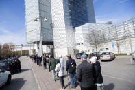 People queue to receive a COVID-19 vaccine, outside the Stockholmsmassan exhibition center turned mass vaccination center, in Stockholm, Sweden, Thursday April 8, 2021. (Fredrik Sandberg/TT News Agency via AP)