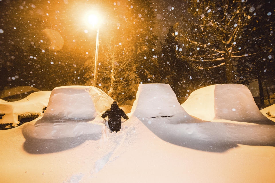 In this photo courtesy of Mammoth Mountain shows parked vehicles under a winter storm sweeping in Mammoth Mountain, Calif., early Sunday Feb. 3, 2019. The National Weather Service said 8 feet (2.4 meters) fell at the June Mountain Ski resort north of Mammoth Lakes and up to 3 feet (0.9 meters) were reported in the resorts around Lake Tahoe since Friday. Forecasters said a blizzard from Sunday night to Monday night could bring another 5 feet (1.5 meters) around Lake Tahoe and another 8 feet (2.4 meters) to the highest elevations, and light snow down to the foothills. (Peter Morning/Mammoth Mountain via AP)