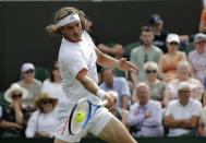 Stefanos Tsitsipas of Greece returns to Italy's Thomas Fabbiano in a Men's singles match during day one of the Wimbledon Tennis Championships in London, Monday, July 1, 2019. (AP Photo/Ben Curtis)