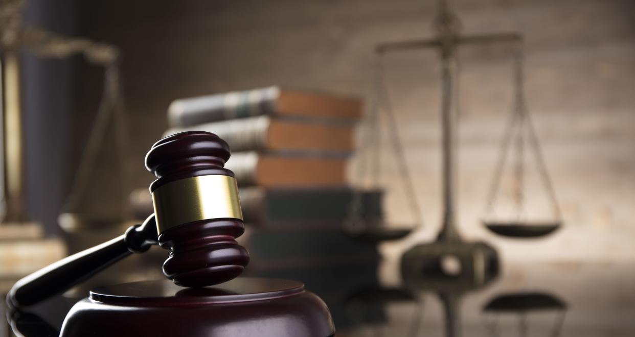 A judge's gavel with the scales of justice in background. (PHOTO: Getty Images)