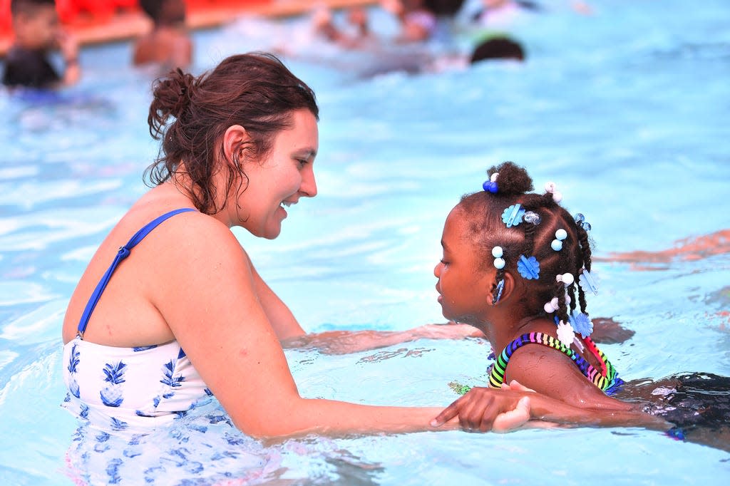 Children take part in the first Willis Road Family YMCA Summer Camp, Monday afternoon, June 8, 2020. Amanda Kreczmer, lead camp counselor, helps Remy Miller, 6, swim in the pool Monday.