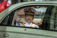 Thailand's King Maha Vajiralongkorn waves from his limousine after officiating a graduation ceremony at Thammasat University in Bangkok, Thailand, Saturday, Oct. 31, 2020. Thailand’s king has presided over a university graduation ceremony at a stronghold of a protest movement seeking to reduce the monarchy’s powers, after activists issued a call for students to boycott the event. (AP Photo/Sunti Teapia)