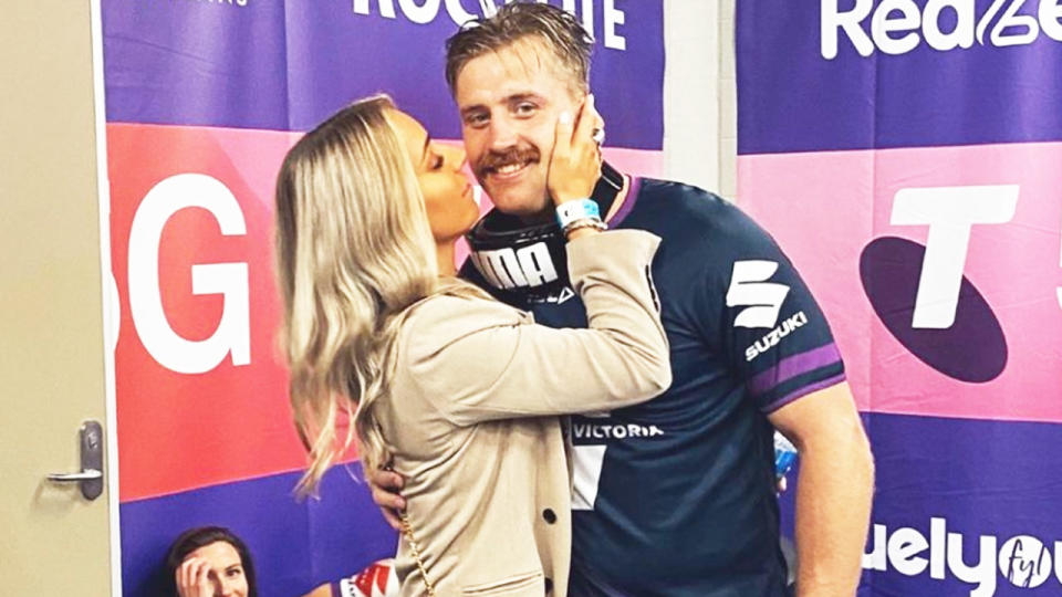 Cameron Munster and Bianca McMahon (pictured) sharing a kiss after the Storm's NRL final victory.