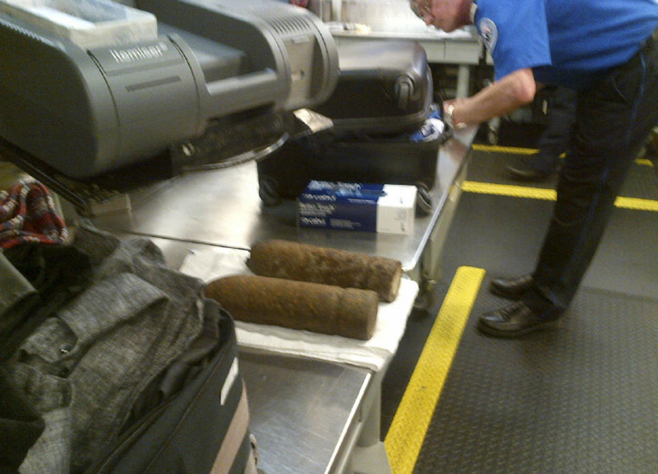 This Monday, April 7, 2014 photo provided by the Transportation Security Administration (TSA) shows two World War I artillery shells discovered by baggage screeners in checked luggage that arrived on a flight from London at Chicago's O'Hare International Airport. The TSA says the bags belonged to a 16-year-old and a 17-year-old who were returning from a school field trip to Europe. A bomb disposal crew determined the shells were inert and no one was ever in danger. The teens were questioned then allowed to travel onward. They weren't charged. (AP Photo/Transportation Security Administration)