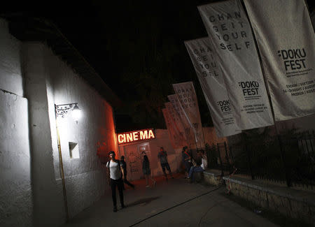 People leave a cinema after watching a film during Dokufest in Prizren, southwest of capital Pristina August 20, 2014. REUTERS/Hazir Reka