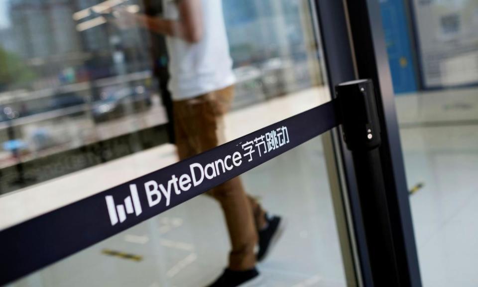 A man walks by a logo of Bytedance, the China-based company which owns the short video app TikTok.