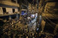 Residents and Lebanese army members inspect a damaged area caused by two explosions in Beirut's southern suburbs, Lebanon November 12, 2015. REUTERS/Khalil Hassan