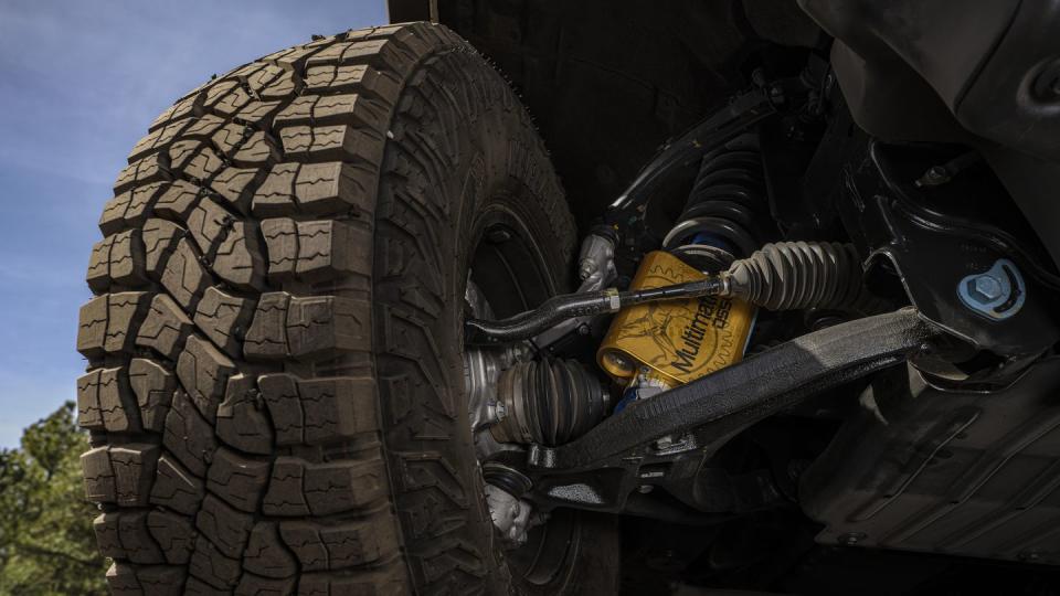 colorado zr2 bisons tire next to multimatic jounce control damper, shown from below