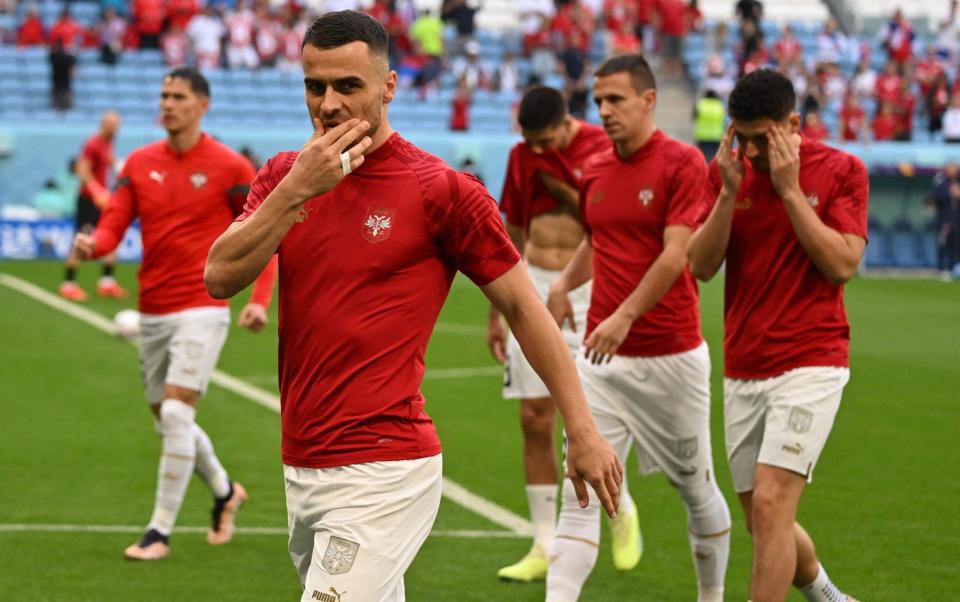 Filip Kostic warms up ahead of the Qatar 2022 World Cup Group G football match - AFP