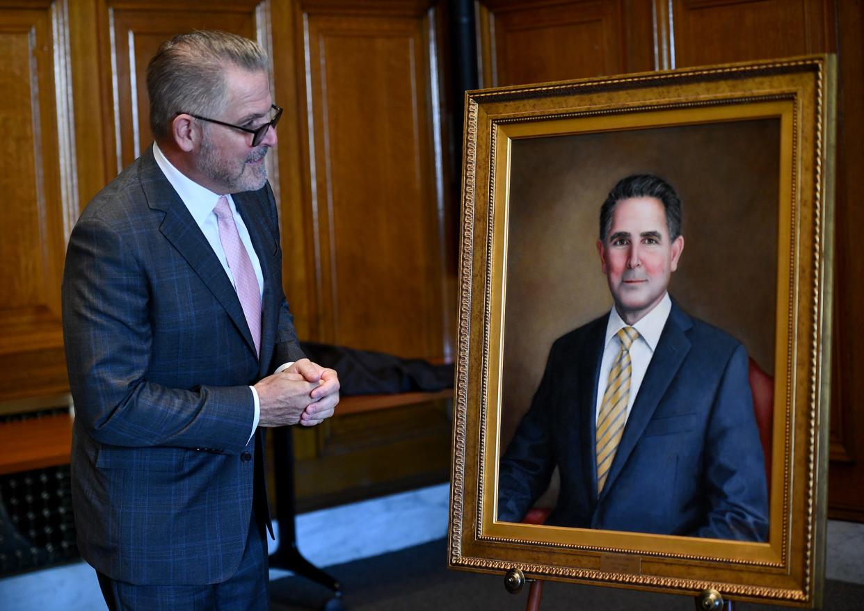 Former Worcester City Manager Michael O'Brien admires his portrait which was unveiled Friday at City Hall.