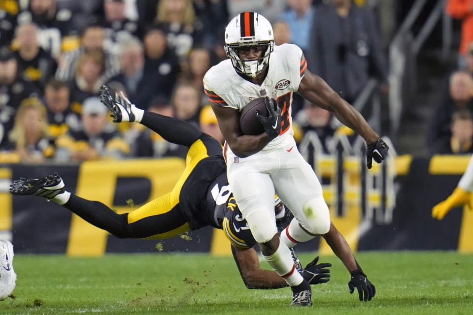 FILE - Cleveland Browns running back Nick Chubb (24) eludes a tackle by Pittsburgh Steelers safety Minkah Fitzpatrick (39) during an NFL football game against the Pittsburgh Steelers in Pittsburgh, Monday, Sept. 18, 2023. The Cleveland Browns have restructured star running back Nick Chubb's contract as he continues to rehab after a season-ending knee injury in 2023, a person familiar with the negotiations told The Associated Press on Thursday, April 11, 2024. (AP Photo/Gene J. Puskar)