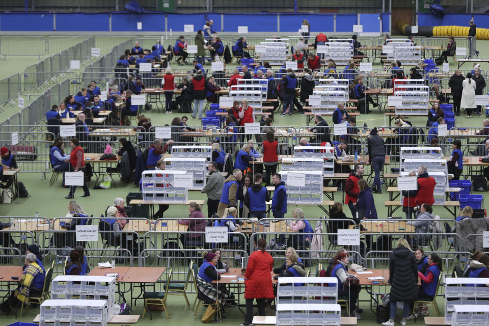 Ballots are counted at the Meadowbank Sports Arena, Magherafelt in Northern Ireland for the 2019 General Election. Thursday Dec. 12, 2019. An exit poll in Britain’s election projects that Prime Minister Boris Johnson’s Conservative Party likely will win a majority of seats in Parliament. That outcome would allow Johnson to fulfil his plan to take the U.K. out of the European Union next month. (Niall Carson/PA via AP)