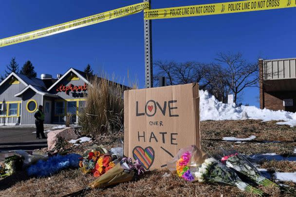 PHOTO: Bouquets of flowers and a sign reading 'Love Over Hate' are left near Club Q, an LGBTQ nightclub in Colorado Springs, Colorado, on Nov. 20, 2022. (Jason Connolly/AFP via Getty Images)