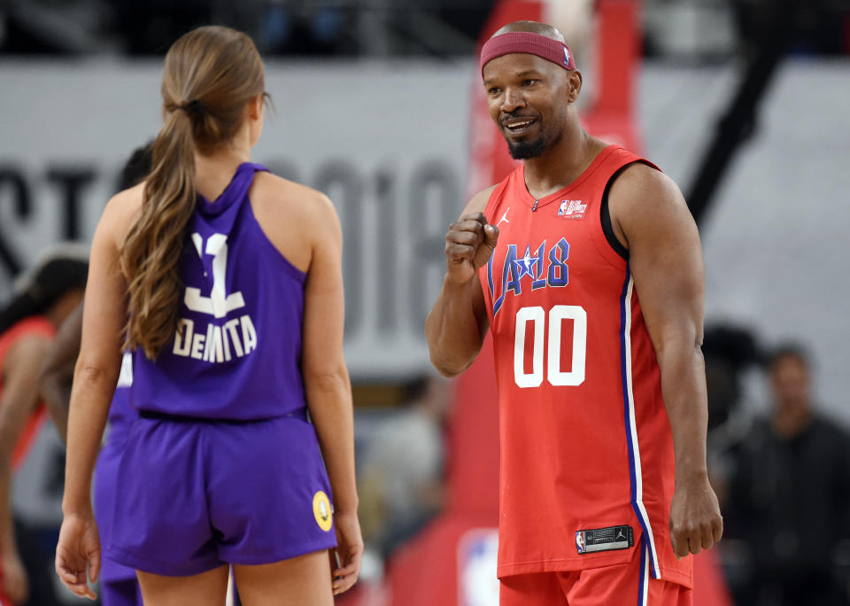 Actor Jamie Foxx banters with with TV personality Rachel DeMita during the NBA All-Star celebrity basketball game in Los Angeles. (AP Photo)