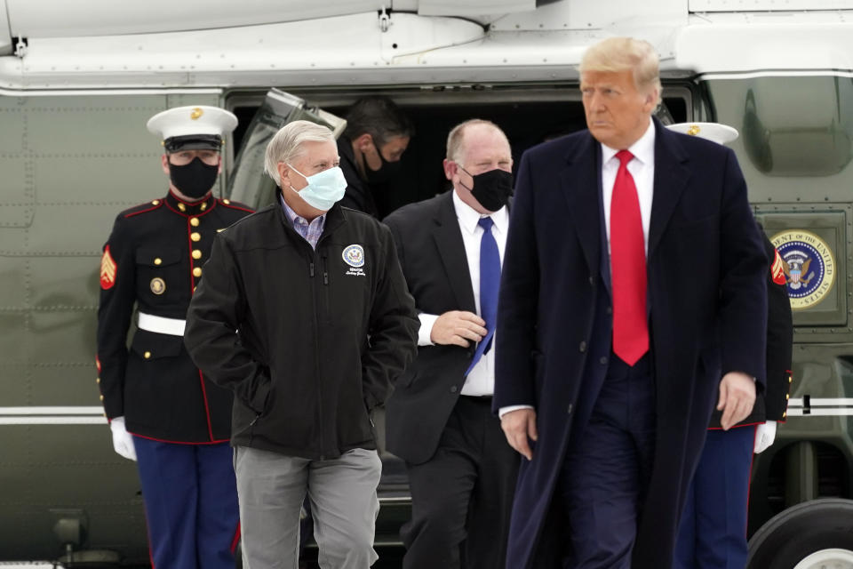 Sen. Lindsey Graham, R-S.C., left, walks with President Donald Trump as they board Air Force One upon arrival at Valley International Airport, Tuesday, Jan. 12, 2021, in Harlingen, Texas, after visiting a section of the border wall with Mexico in Alamo, Texas. (AP Photo/Alex Brandon)