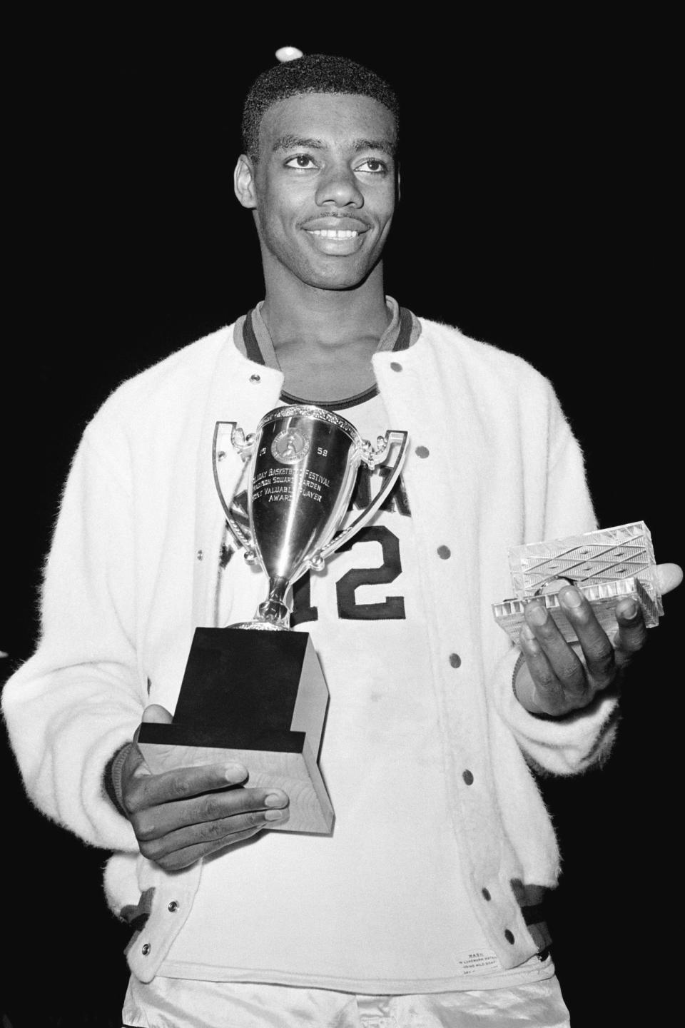 FILE - In this Dec. 30, 1959, file photo, Cincinnati's Oscar Robertson poses with the Most Valuable Player award after leading his team to the ECAC Holiday Festival Championship at New York's Madison Square Garden. Cincinnati defeated Iowa 96-83. Four of the top five tournament triple-doubles pre-1986 belong to Robertson. (AP Photo/File)