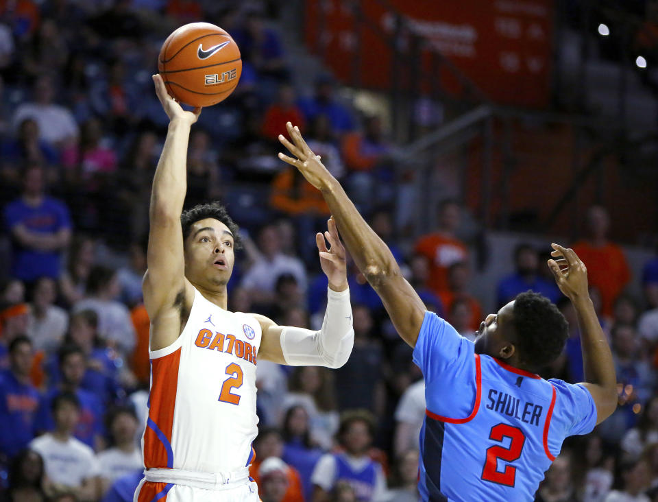 Florida guard Andrew Nembhard (2) shoots over Mississippi guard Devontae Shuler (2) during an NCAA college basketball game Tuesday, Jan. 14, 2020, in Gainesville, Fla. (Brad McClenny/The Gainesville Sun via AP)