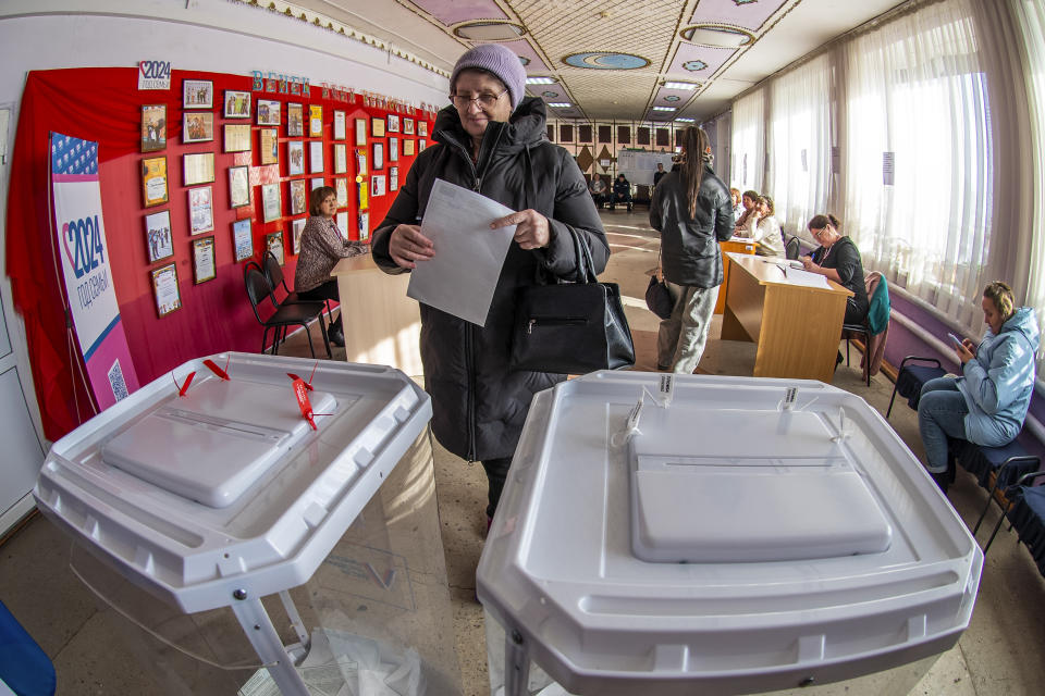 A woman walks to cast her ballot at a polling station during a presidential election village of Chikcha, Tyumen municipal district, western Siberia, Russia, Sunday, March 17, 2024. Voters in Russia are going to the polls for the last day of a presidential election that is all but certain to extend President Vladimir Putin's rule after he clamped down on dissent. (AP Photo)