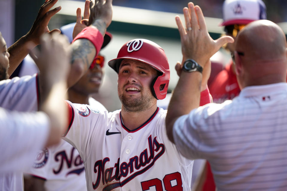 Washington Nationals' Lane Thomas celebrates after scoring during the third inning of a baseball game against the New York Mets at Nationals Park, Monday, May 15, 2023, in Washington. (AP Photo/Alex Brandon)