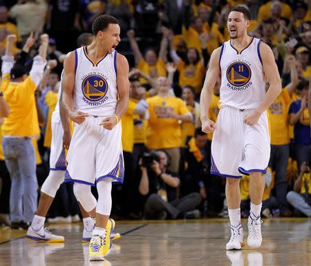 Golden State Warriors guard Stephen Curry (30) and guard Klay Thompson (11) celebrate the 99-98 victory against the Houston Rockets following the second half in game two of the Western Conference Finals of the NBA Playoffs. at Oracle Arena. Mandatory Credit: Cary Edmondson-USA TODAY Sports