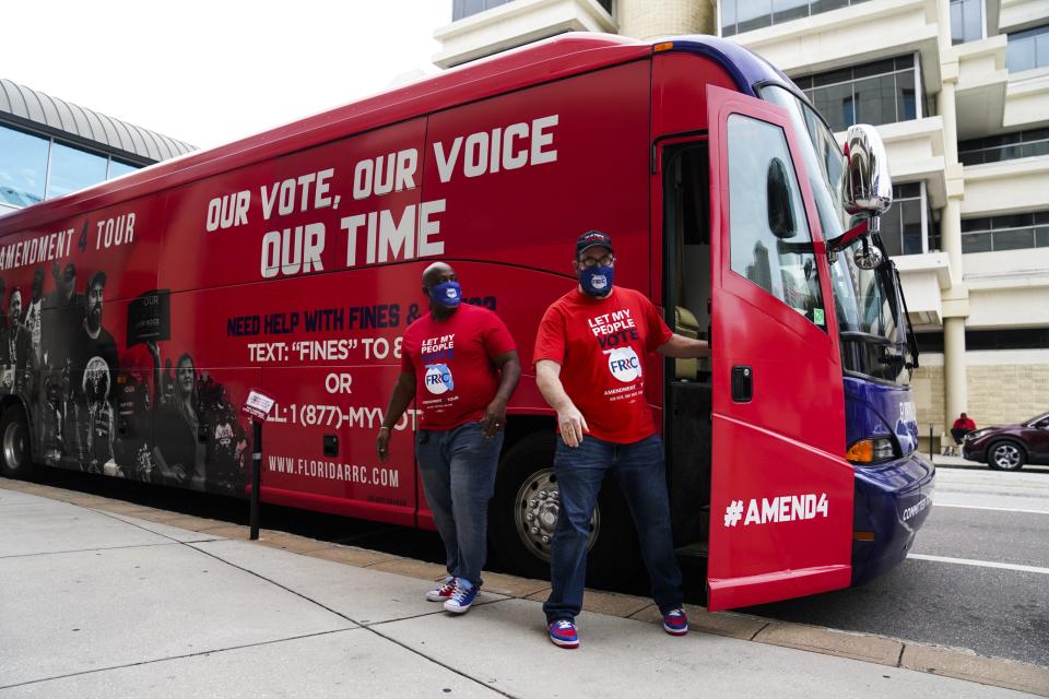 Meade and Volz get out of a van saying: Amendment Tour, Our Vote, Our Voice, Out Time; Need Help With Fines, www.floridarrc.com.