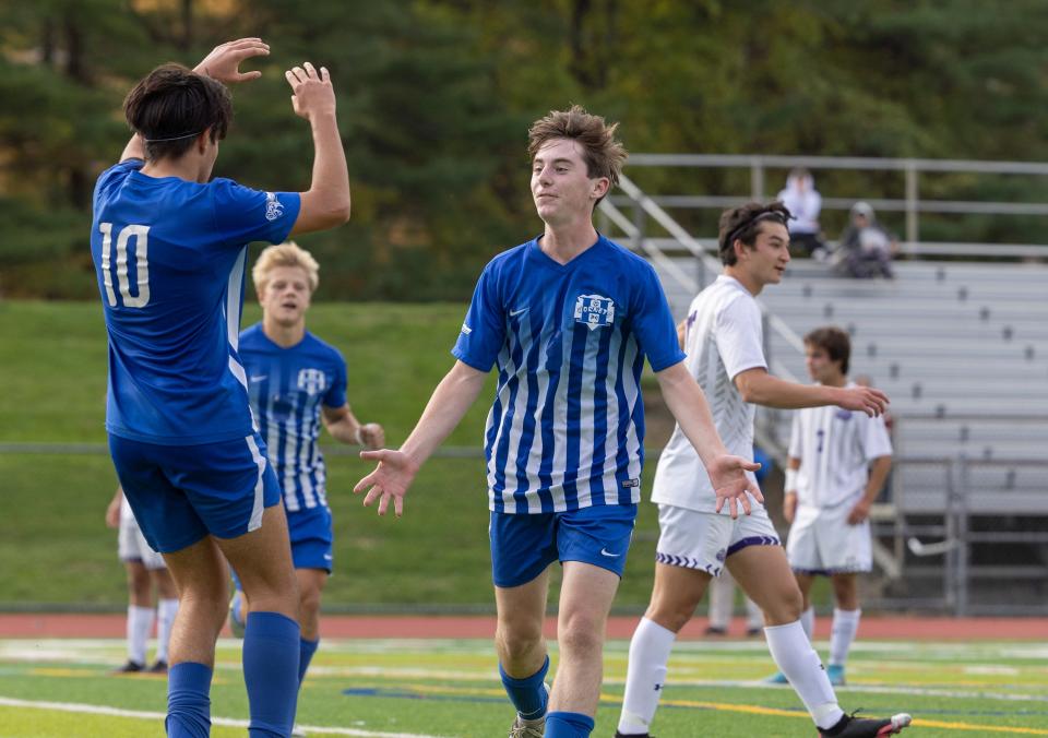 Holmdel David Weiner celebrates with team mates after he kicks in a penalty shot to make it 2-0. Holmdel Boys Soccer defeats Rumson-Fair Haven 2-0 in NJSIAA State playoff game in Holmdel, NJ on October 31, 2022. 