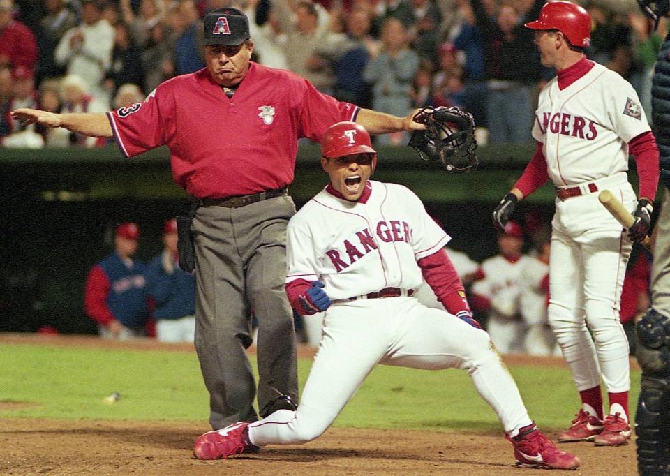 Umpire Derryl Cousins calls Ivan “Pudge” Rodriguez safe as he scores the winning run in a 1996 game (Star-Telegram file photo)