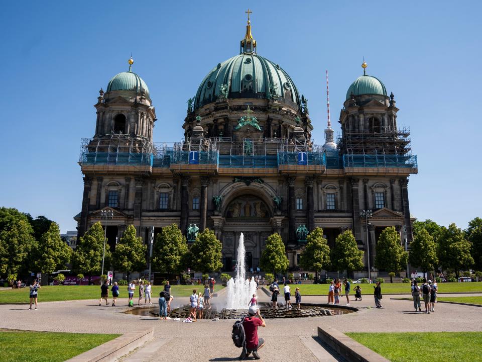 People cool off in the fountain in front of the Berlin Cathedral on July 19, 2022.